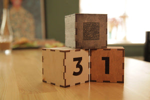 Wooden cube with the number and qr-code